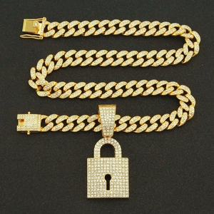 Iced out gold Cuban link chain for men featuring a sparkling crystal padlock pendant