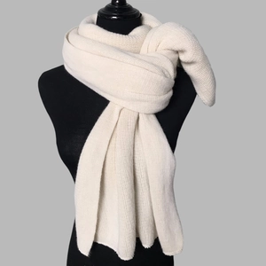 Macro view of thick knit texture on this warm cream white winter scarf for women and men
