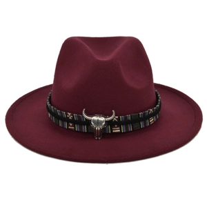 Detail of wine red felt fedora featuring an ethnic woven band and silver bull head charm
