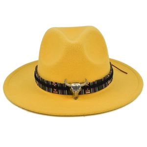 Detail of yellow wool fedora hat with ethnic woven band and silver bull head accessory