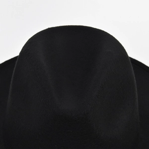 Detailed view of the crown on a classic black felt fedora hat with a smooth texture