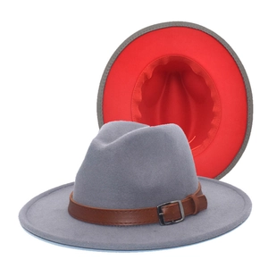Detail of grey wool fedora hat with red inner lining and brown leather buckle band