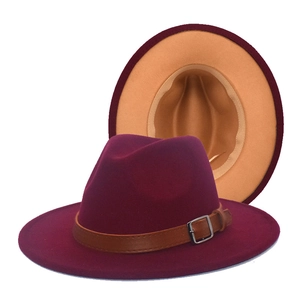 Detail view of burgundy wide-brim fedora hat with camel lining and buckled leather band