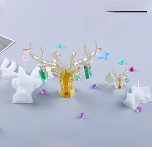 Macro detail of DIY silicone mold showing translucent deer head jewelry organizer with gold foil