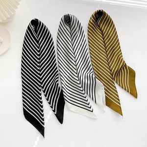 Set of three striped 70cm silk-like scarves in black, white, and brown on white surface