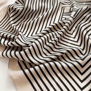 Macro shot of striped silk scarf texture showing smooth fabric and geometric pattern