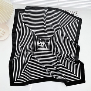 Detailed view of 70cm silk square scarf with classic black and white stripes and elegant folds