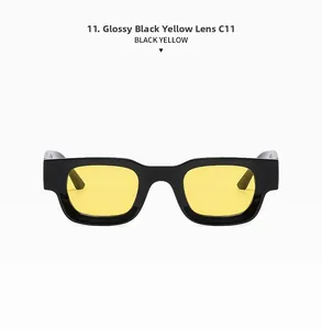 Detail of polished black sunglasses frame with vibrant yellow lenses in model C11
