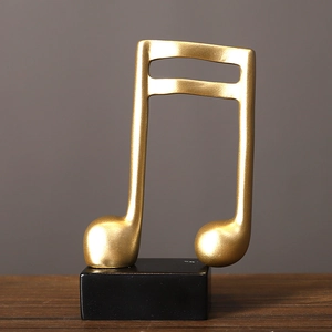 Modern gold musical note sculpture on black base for elegant desktop decor