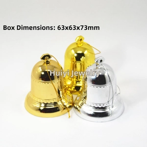 Macro view of gold and silver decorative bell ornaments with metallic reflective finish