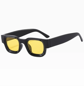 Detail of vintage square black frame sunglasses with yellow lenses from a 45-degree angle