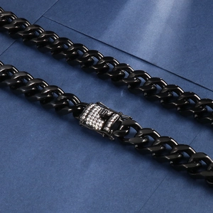 Macro detail of black Cuban link necklace with iced out crystal encrusted clasp