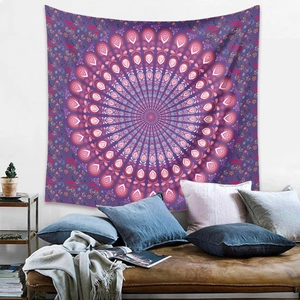 Detail of bohemian mandala tapestry featuring pink geometric patterns on a purple background