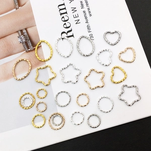Detailed view of DIY geometric alloy charms with hammered texture in gold and silver