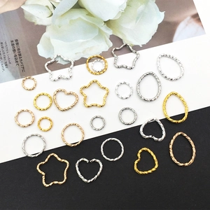 Assorted DIY metal jewelry charms with textured star, heart and circle shapes in gold and silver