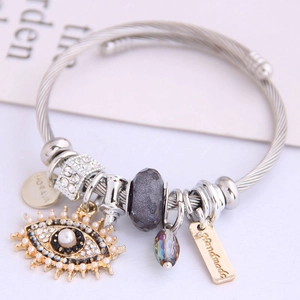 Silver cable wire bangle with evil eye charm, pearls, and engraved pendants for women