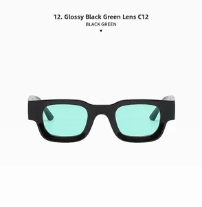 Macro shot of stylish square sunglasses in glossy black frame with mint green lenses