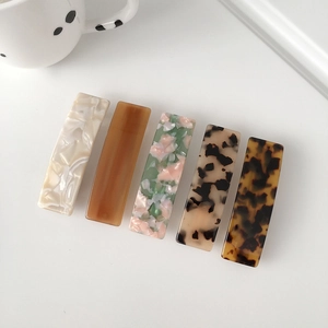 Five assorted 8.5cm acetate rectangle hair clips in marble and tortoise patterns