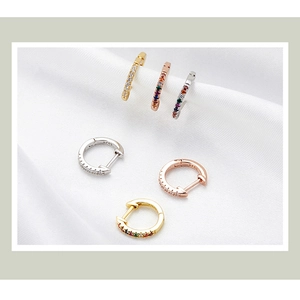 Detail view of S925 sterling silver stamp on gold, silver, and rose gold hoop earrings