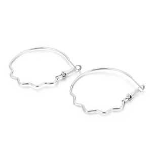 Minimalist silver wavy large hoop earrings with a polished metallic finish on white background