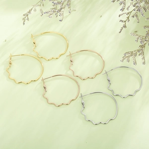 Three pairs of large hoop earrings with wavy texture in gold, rose gold and silver