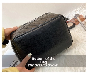 Detail view of the quilted black PU leather makeup bag with a reinforced flat bottom