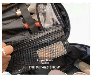 Detail view of large travel makeup bag interior with zipper mesh pocket and brush slots