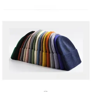 Collection of thick knitted beanies in ten different colors for winter outdoor warmth