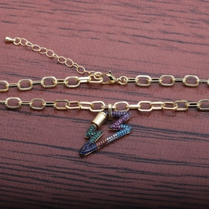 Hip hop style gold chain necklace with colorful zircon lightning pendant on wood