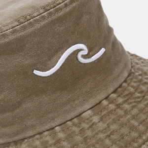 Detailed view of white wave embroidery on washed cotton earth tone bucket hat fabric