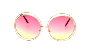 Detail of round gold metal frame with pink-yellow gradient lenses on white background
