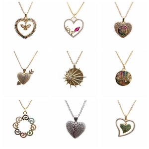 Set of gold necklaces with colorful zircon heart, sun, and love pendants on white background
