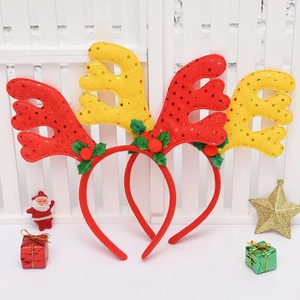 Close-up of red and yellow sequin reindeer antler headbands with holly leaf Christmas decor