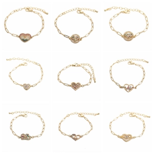 Nine assorted gold Hip Hop bracelets with colorful zircon heart and round charms on white