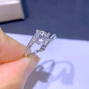 Close-up of a four-prong set 1 carat round cubic zirconia ring with sparkling side stones