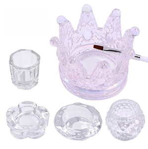 Macro shot of glass crown and faceted crystal nail cups for acrylic liquid and brush cleaner