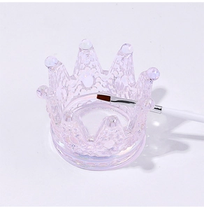 Iridescent purple crown glass nail art cup holding a professional manicure brush