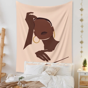 Detail of bohemian wall tapestry featuring abstract female portrait and warm room decor