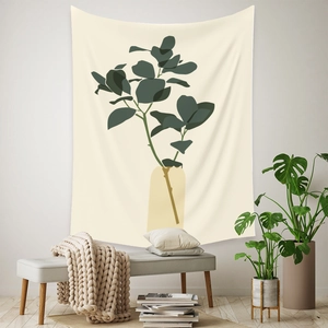 Detail of bohemian tapestry featuring green plant illustration in a warm living room setup