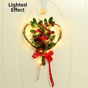 Detail of heart-shaped Christmas wreath with red berries, stars, and warm LED lights