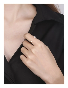 Detailed close-up of S925 silver ring featuring pearl and zircon on a gold band