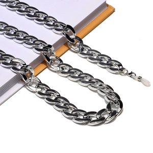Silver acrylic chunky Cuban link eyewear chain with anti-slip silicone loops on a notebook