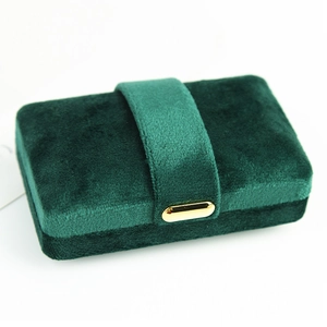 Dark green velvet jewelry box with golden clasp for rings and pendants storage