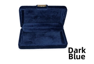 Detail of dark blue velvet jewelry box with golden buckle and interior chain rolls