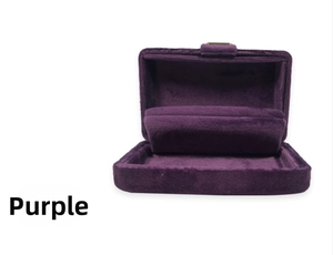 Macro detail of purple velvet jewelry box with golden buckle and soft padded interior