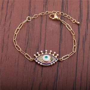 Hip Hop Evil Eye bracelet with gold chain and colorful enamel rhinestones on wood background