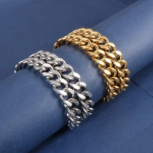 Detail of gold and silver cuban link chains on a blue display stand with hip-hop style