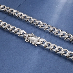 Macro shot of silver curb chain links and box clasp with double security side clips