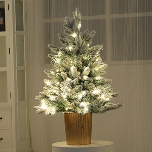 Miniature flocked PE Christmas tree with warm LED lights in a golden metal base pot