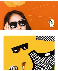Close-up of black pixel mosaic sunglasses and checkerboard vest on orange background